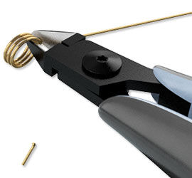 Flush-cutters cutting the coiled wire